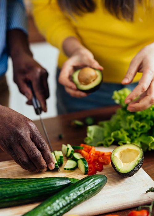 cinematic image of a multiethnic senior couple preparing food in the kitchen. Indoors Lifestyle moments at home. Concept about seniority and relationships