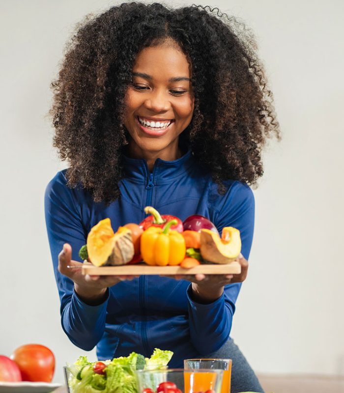 Fit woman enjoys healthy fruit breakfast after yoga training. fitness, nutrition, home lifestyle.